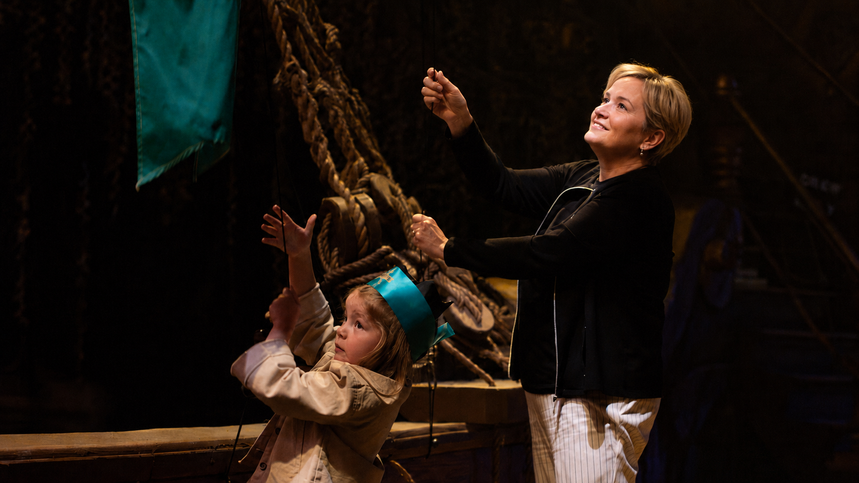 Guests cheering during the live pirate dinner show