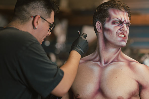 Cesar Castano adding makeup to a Vampirate