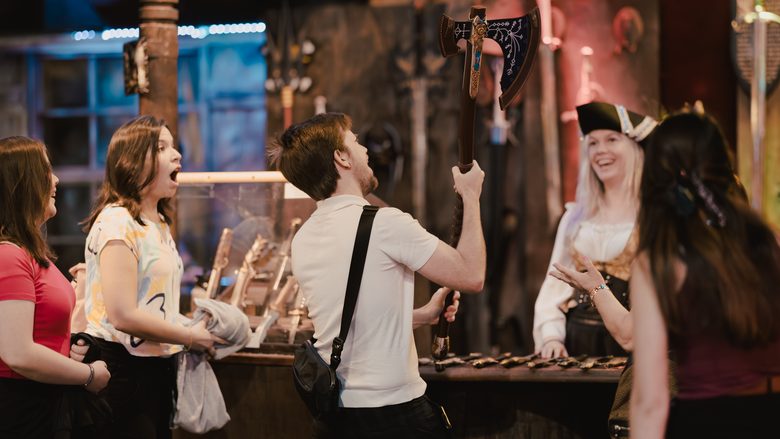Guests react with delight at the axe-throwing display