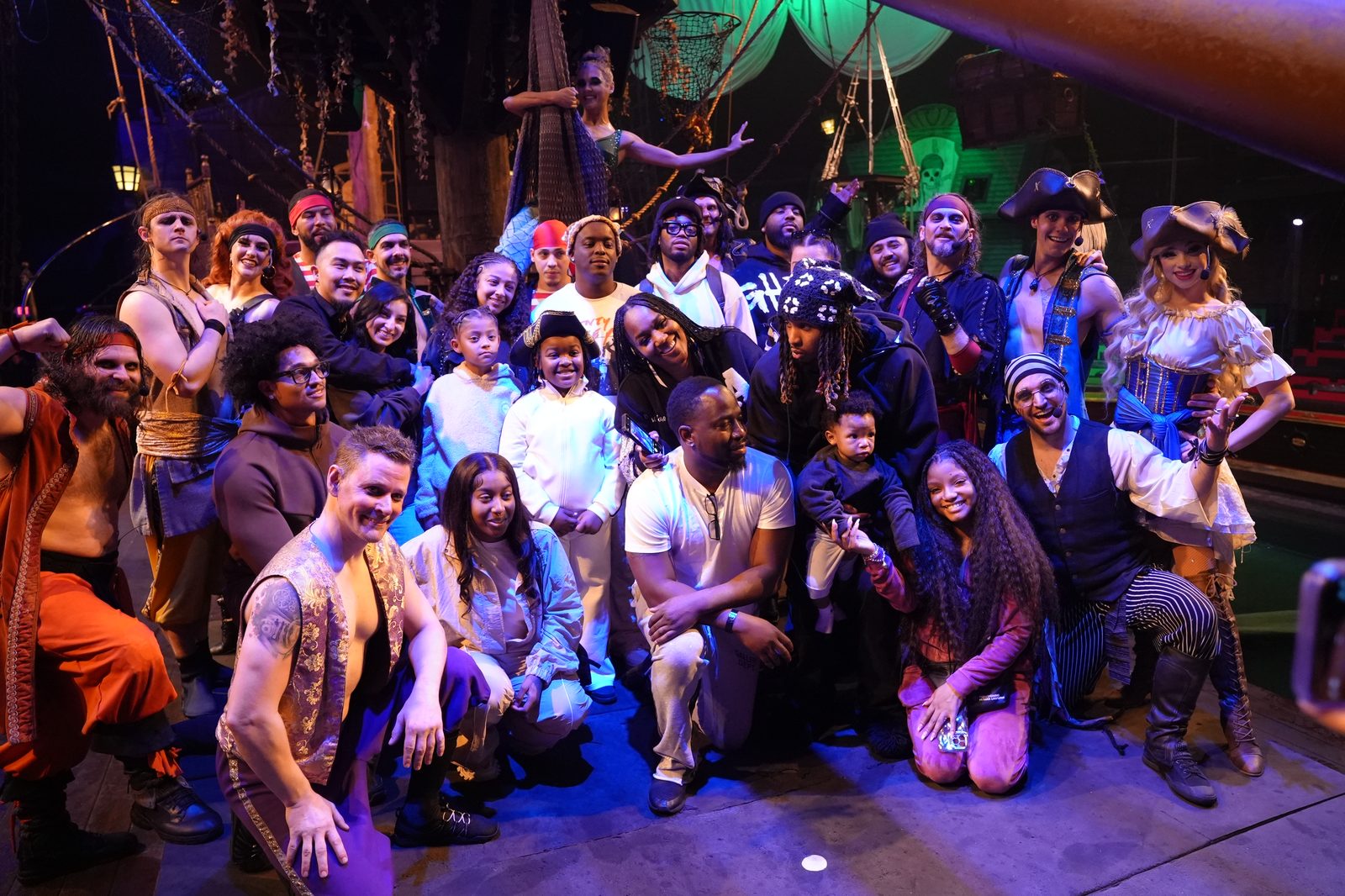 The Pirates Dinner Adventure cast celebrates on stage with a guest family